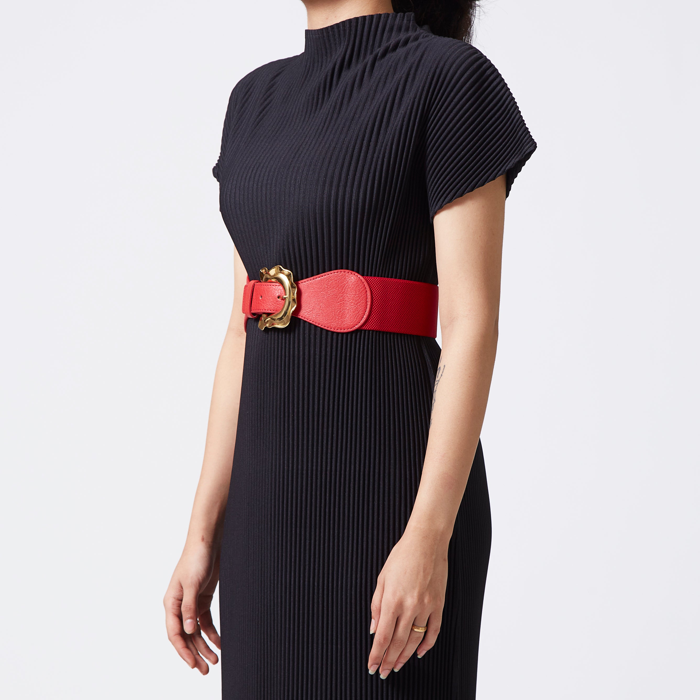 Red elastic-backed belt with gold distended buckle
 Red elastic-backed belt with gold distended buckle